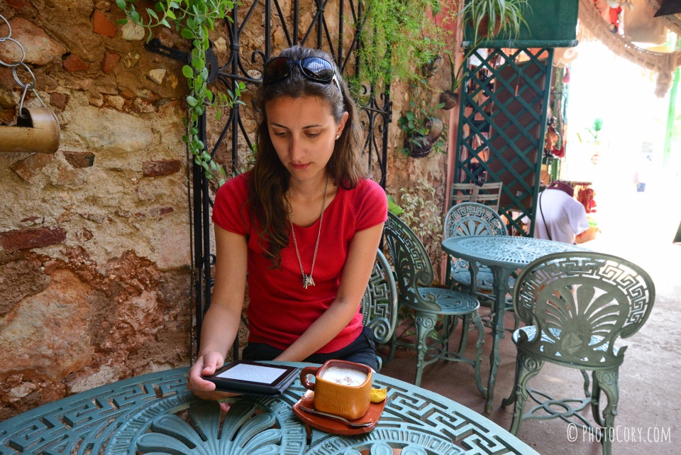 reading from kindle in cafe restaurant plaza mayor trinidad cuba